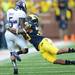 Michigan safety Thomas Gordon tackles Northwestern tailback Vernic Mark during the third quarter at Michigan Stadium on Saturday. Melanie Maxwell I AnnArbor.com